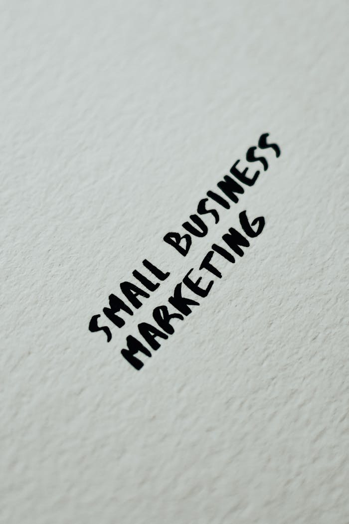 Crafting Captivating Headlines: Your awesome post title goes here Close-up of small business marketing text handwritten on a white textured background for entrepreneurial themes.