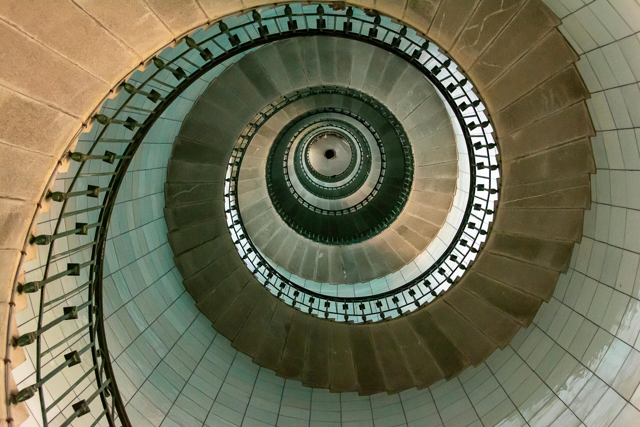 A captivating view of a spiral staircase inside a lighthouse, showcasing architectural elegance.